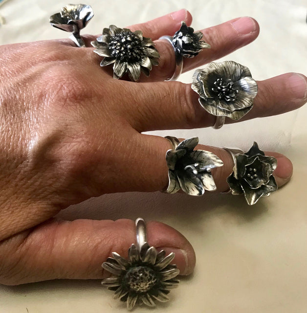 One of a kind sterling silver rings, each hand fabricated from sheets of silver and wire. Choose from a garden of flowers: magnolia, hollyhock, daisy, sunflower, carnation hibiscus, poppy, lily,and daffodil