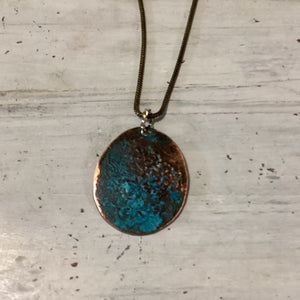 Medallion pendant with antique patina