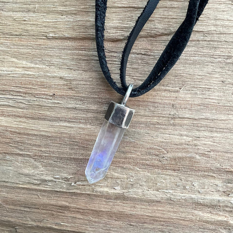 Hand Made oxidized silver setting with raw crystal pendant suspended on black leather. 