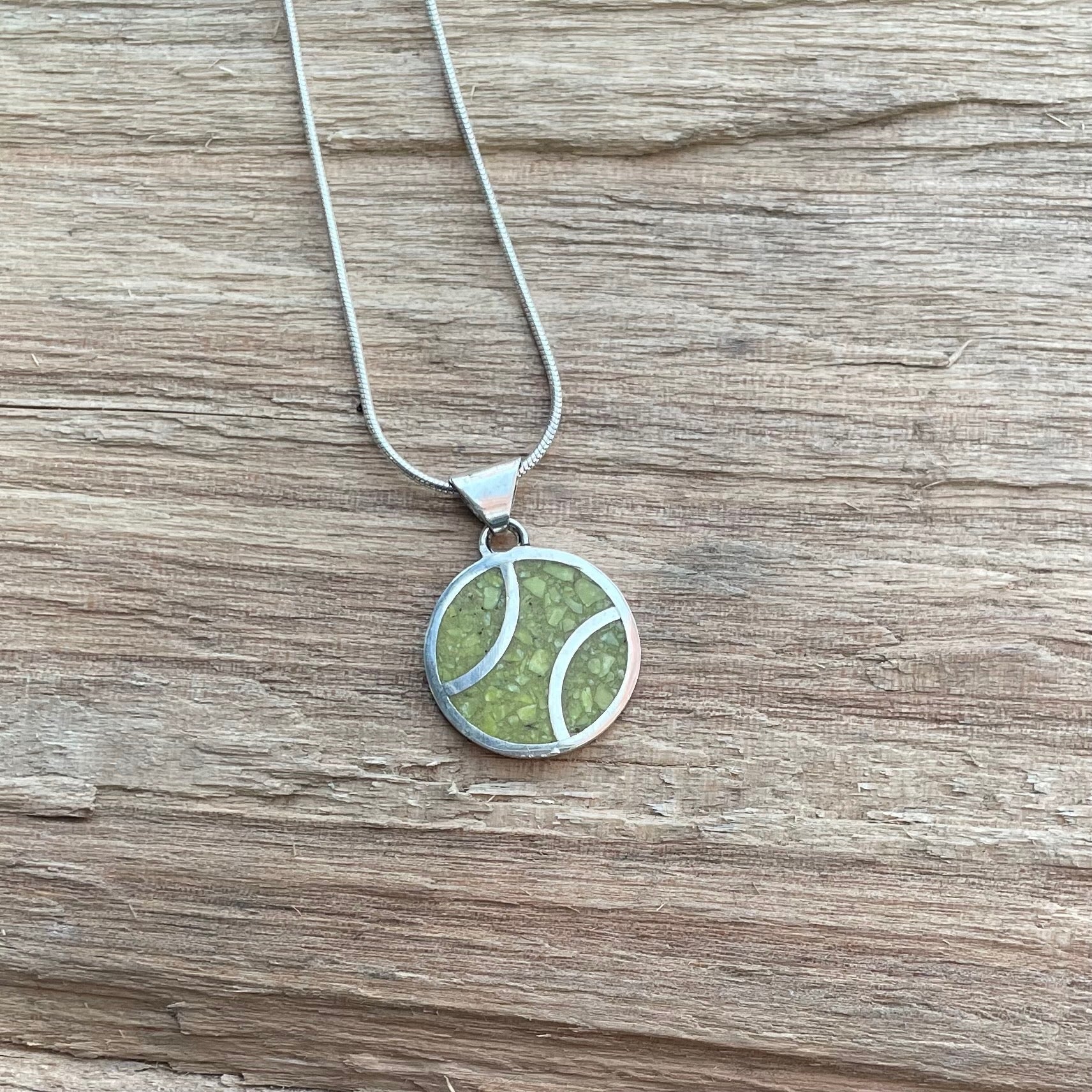 Sterling silver snake chain with crushed inlaid yellow stone peace pendant.  About size of a quarter.