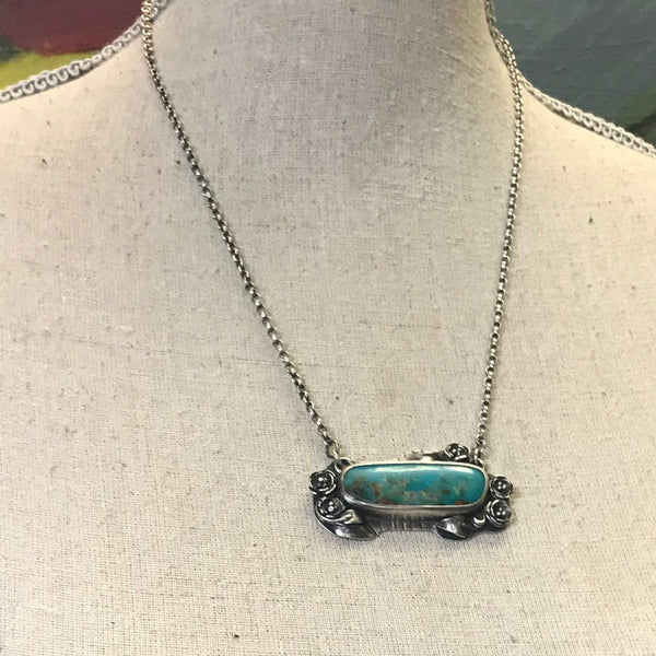 Turquoise horizontal pendant with sculpted silver setting and sterling silver  rolo chain.